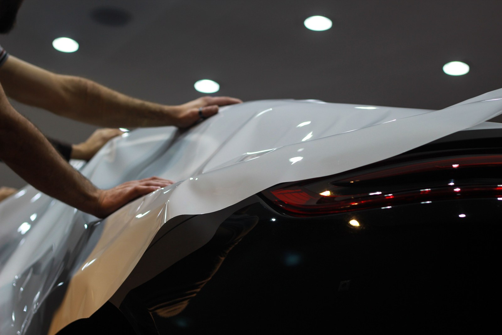 Vehicle wrap film being applied to a car panel